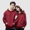 Couple of male and female lovers walking in dark red hoodies