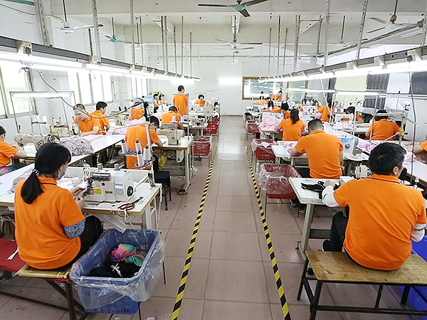 Workers in the Modaknits production workshop are carefully producing long-sleeved T-shirts
