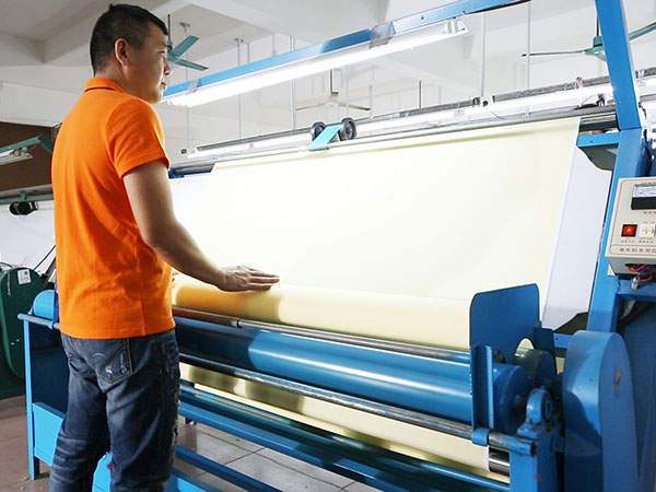 Worker is inspecting fabric