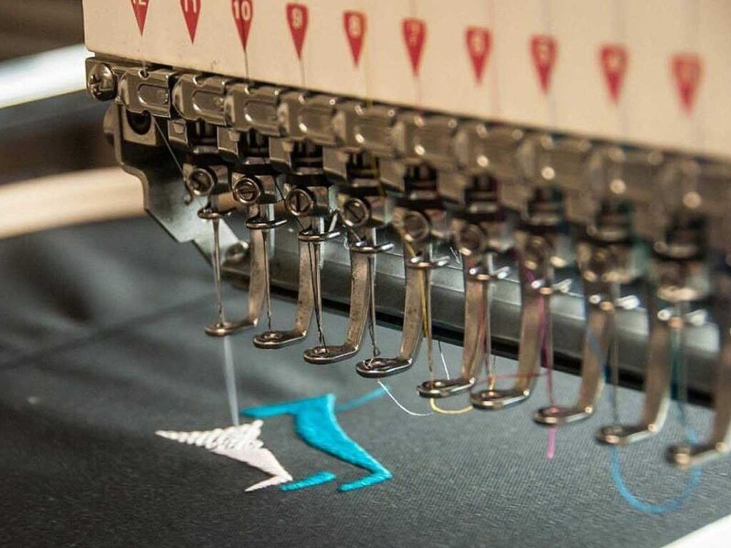 Embroidery machine is embroidering Activewear