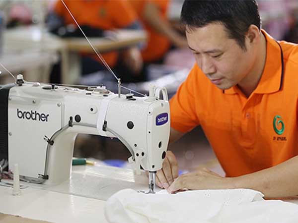 The clothing prototype maker is making new samples based on the design draft.