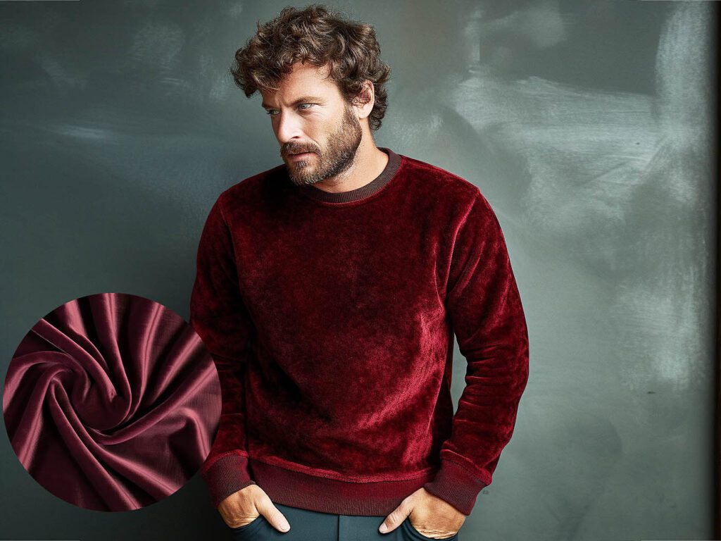 A man wears a sweatshirt made of Velvet Knit fabric solid color