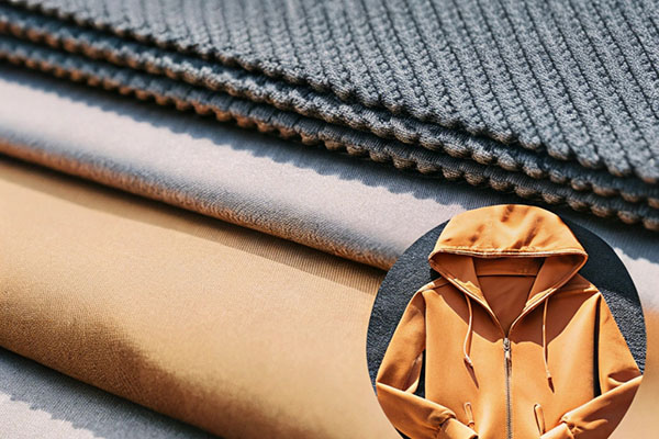 Stacked fabric layers in various textures and colors with an inset image of an orange hoodie.