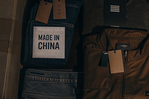 Close-up of clothing with tags, including a label reading