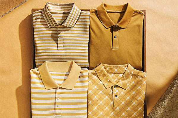 Four yellow-toned polo shirts in striped, solid, and checkered patterns, neatly arranged against a warm background.