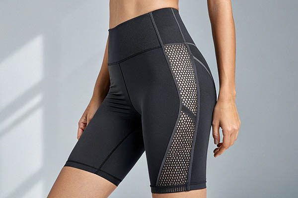 Black high-waisted shorts with mesh side panels for breathability.