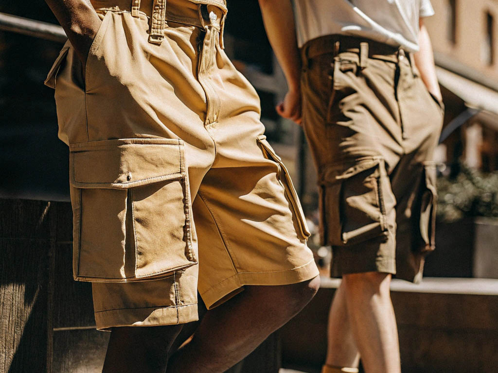 Men wearing tan and olive cargo shorts with utility pockets.