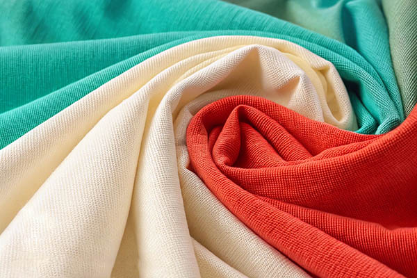 Swirled red, cream, and green knit fabric textures.