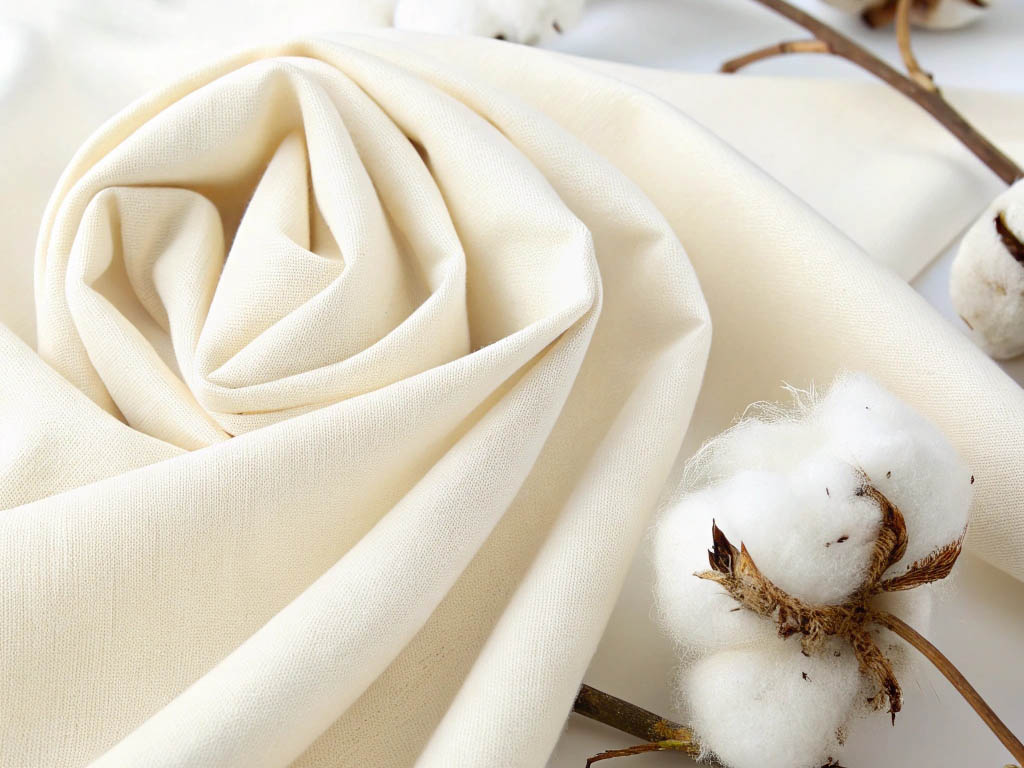Natural cotton fabric with raw cotton branches.