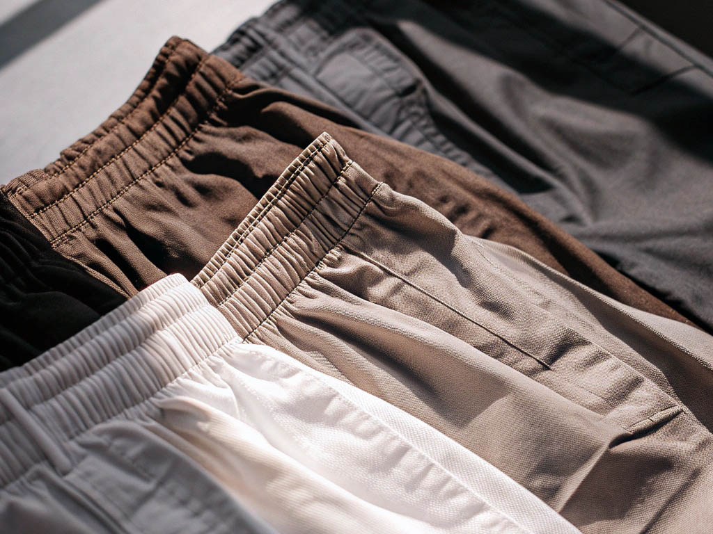 Assorted brown and beige drawstring shorts in soft lighting.