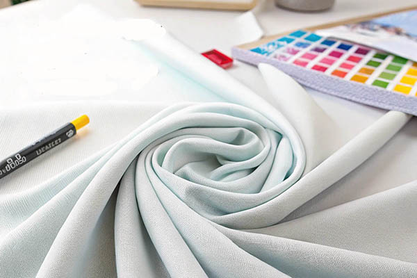 Soft fabric with color palette and marker on designer's table.
