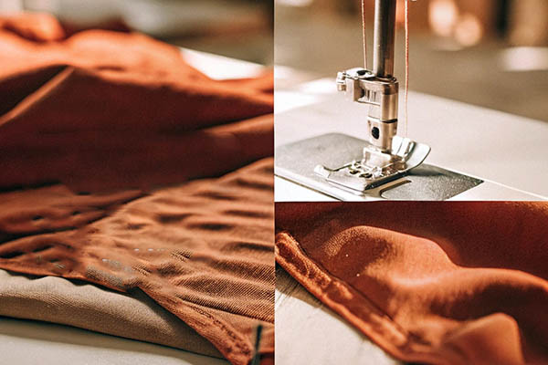 Close-up of sewing machine stitching brown textured fabric.