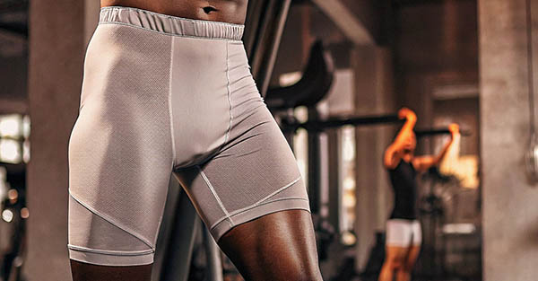 Gray compression shorts with mesh panels at the gym.