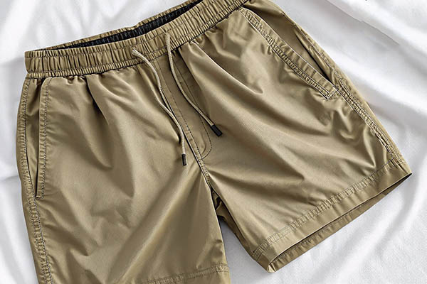 Khaki shorts with elastic waistband and side pockets.