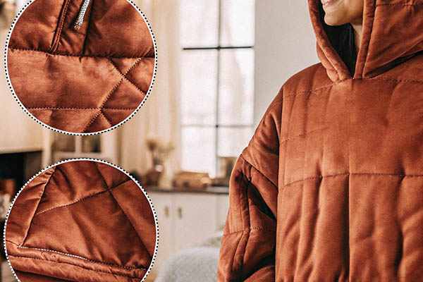 Warm, brown oversized hoodie with quilted stitching details, soft fabric, and a large hood.