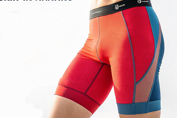 Red and blue compression shorts with mesh panels and textured fabric.
