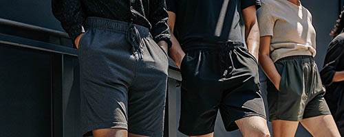 Group wearing minimalist black and gray shorts outdoors.