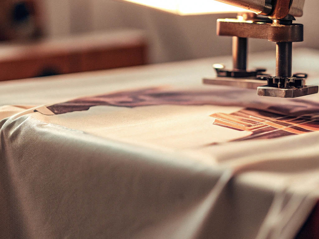 Close-up of a heat press machine transferring a design onto a fabric surface.