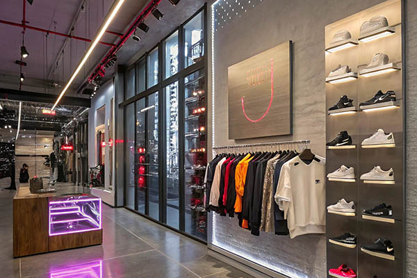 Fashionable sneaker and clothing store with modern decor.