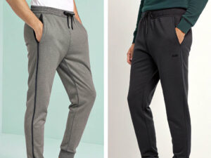 Two men wearing slim-fit jogger pants, one in gray with a side stripe and one in black, styled with casual tops.
