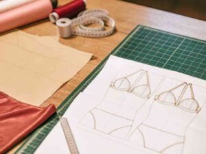 Lingerie pattern sketches with fabric and sewing tools