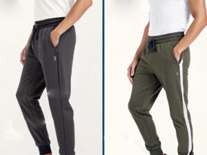 Two models wearing sporty jogger pants in black and olive green with zippered pockets.