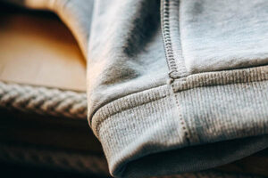 Close-up of a sweatshirt cuff showcasing ribbed fabric, stitching, and soft material texture.