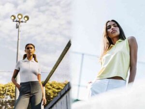 Women in fitted polos on tennis court.