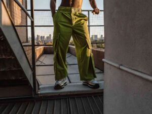 Man in bright green wide-leg cargo pants on rooftop