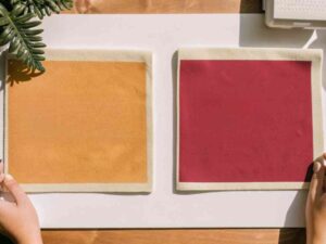 Two square suede fabric swatches in mustard and red.