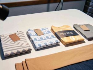 Folded patterned shirts with tags displayed on a white table