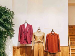 Mannequins in stylish tailored outfits in retail fashion setting.