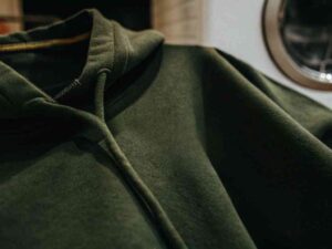 Close-up of dark green fleece hoodie fabric texture