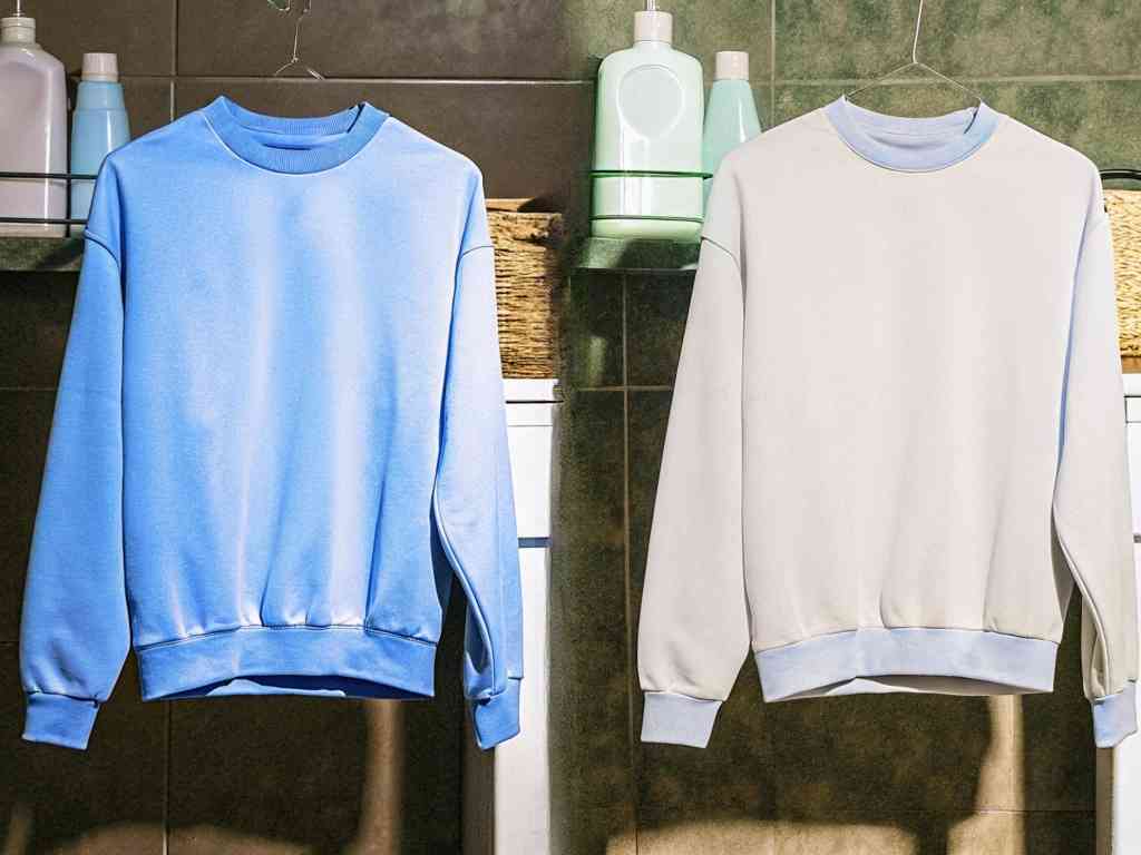 Blue and white sweatshirts hanging in laundry room