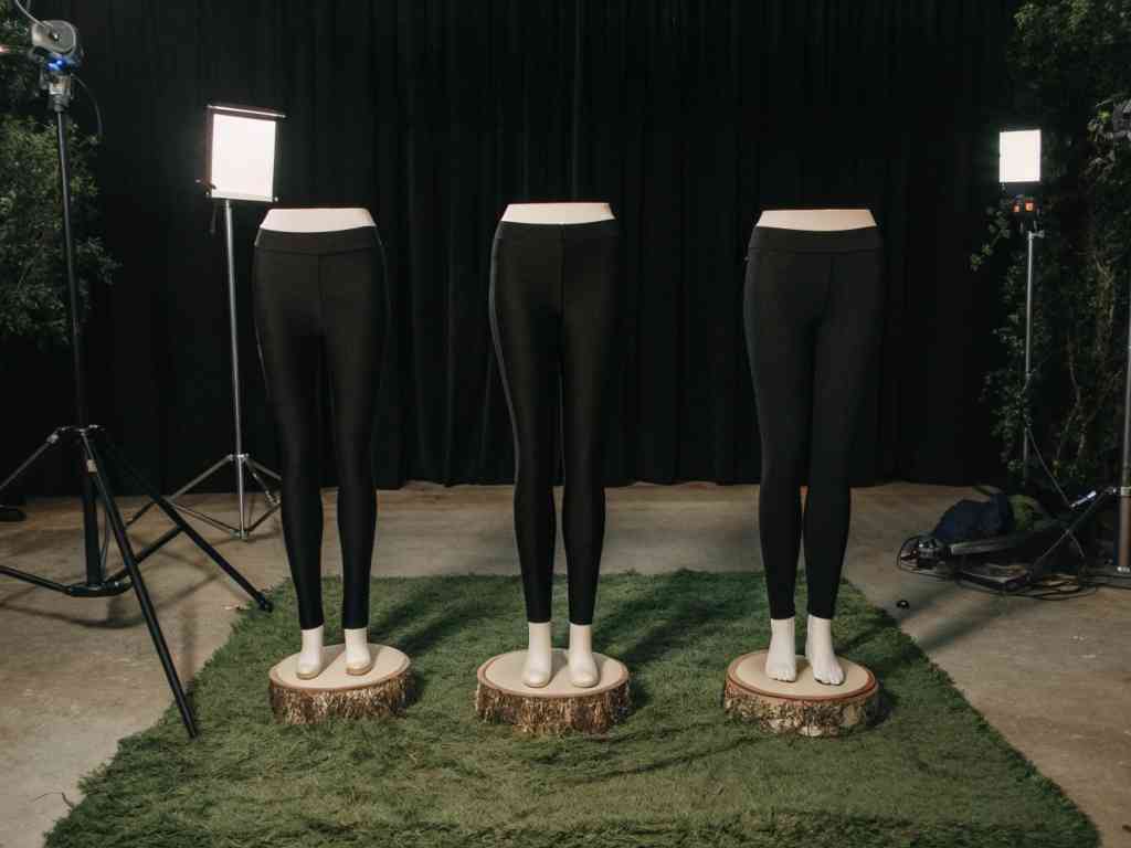 Three black leggings on mannequins with studio lighting