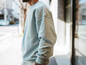 Man wearing light blue sweatshirt outdoors
