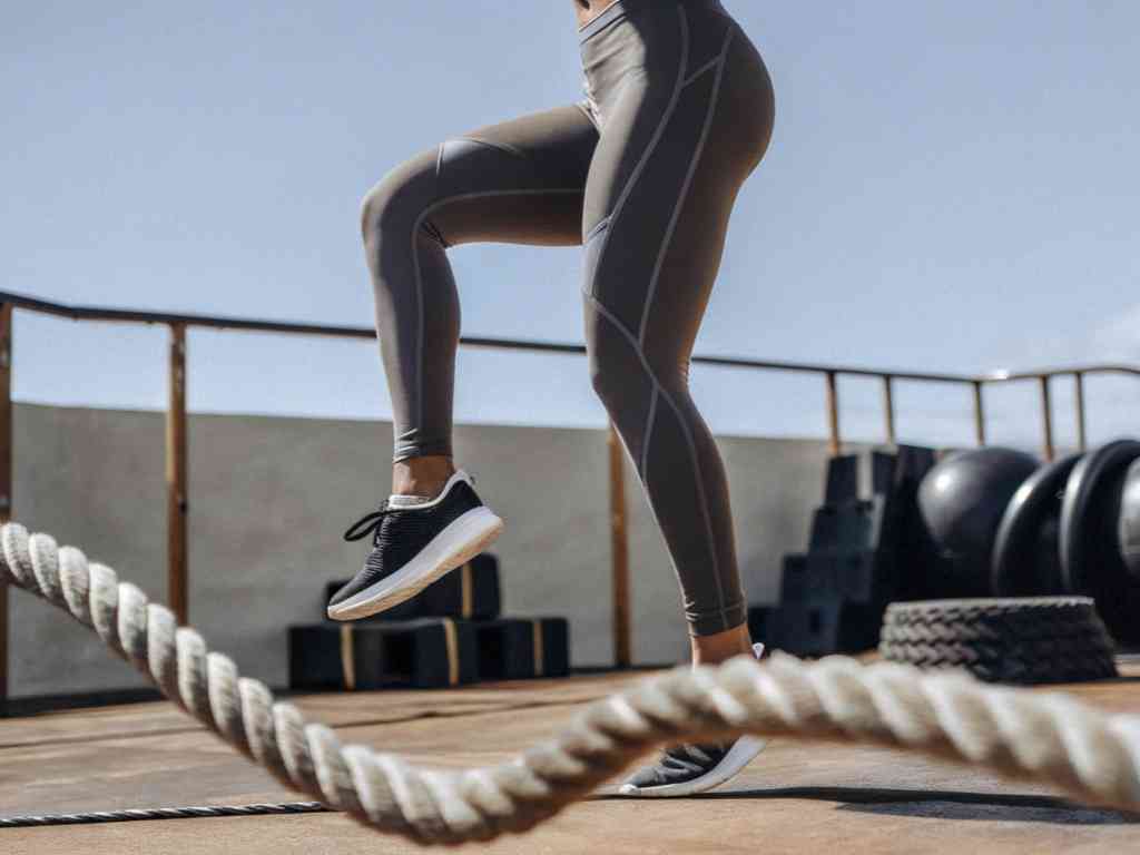 Woman training outdoors in gray workout leggings