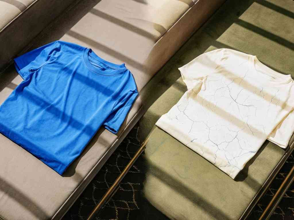 Blue and white T-shirts neatly folded on cushioned benches
