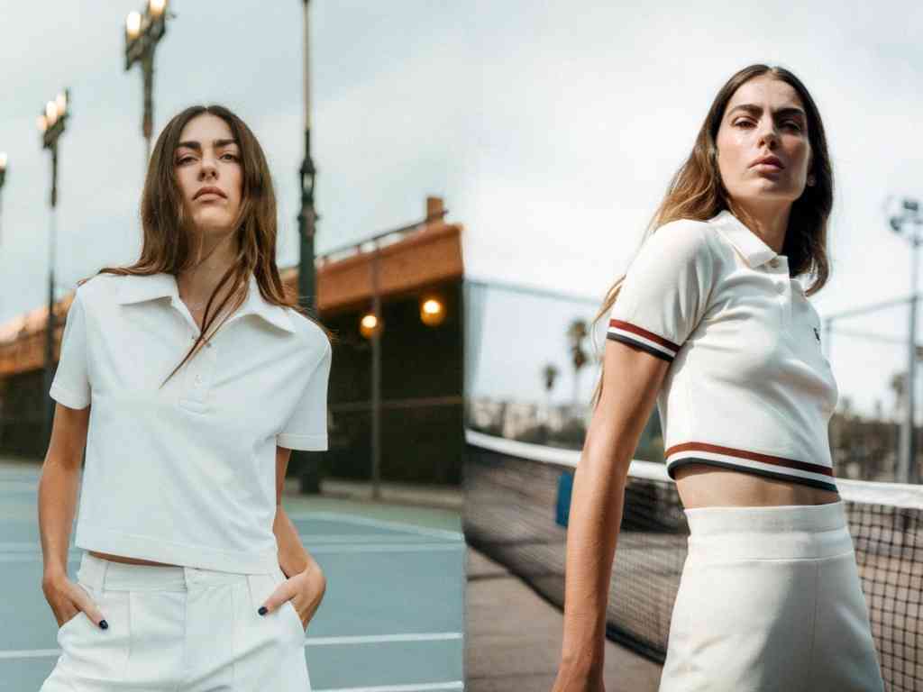 Woman in cropped tennis polo on court.