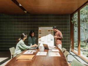 Team collaborating on brand project at sunny modern office.