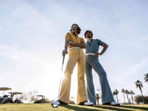 Retro-styled golfers pose confidently on green.