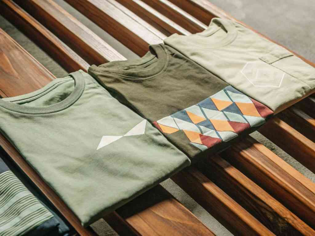 Three folded graphic t-shirts with minimalist and geometric prints