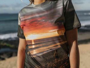 Close-up of woman wearing t-shirt with ocean sunset and figure print
