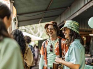 Smiling friends wearing casual streetwear at an outdoor festival