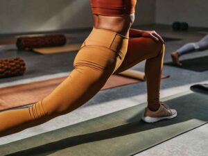 Stretchy spandex leggings in lunge pose during yoga session