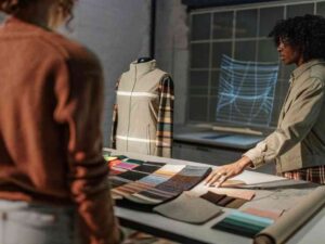 Designer showcasing fabric swatches beside a sample garment