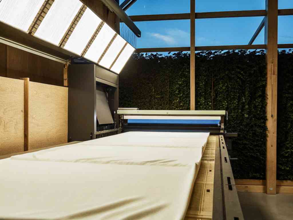 Printing machine with white fabric under large lights