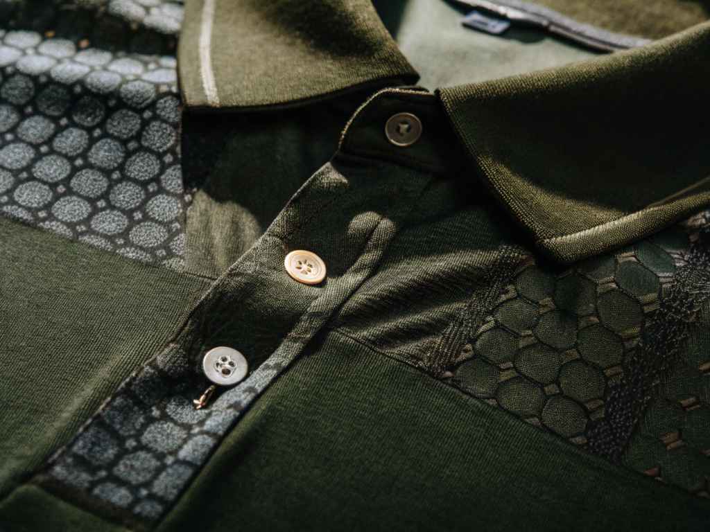 Olive green polo shirt with mixed geometric knit textures.