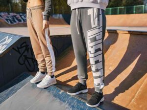 Streetwear joggers in tan and gray with graphic and stripe details