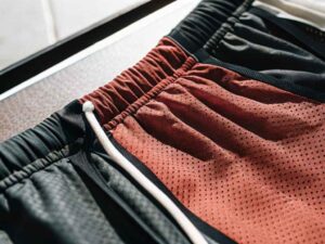 Close-up of red mesh athletic shorts with drawstring waistband